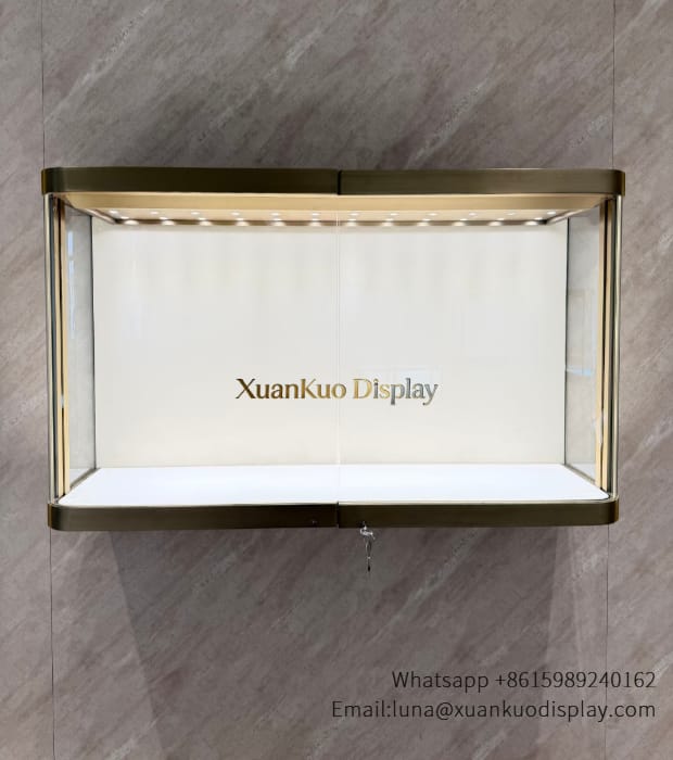 Wall mounted glass case designed to showcase fine necklaces in jewellery boutique.