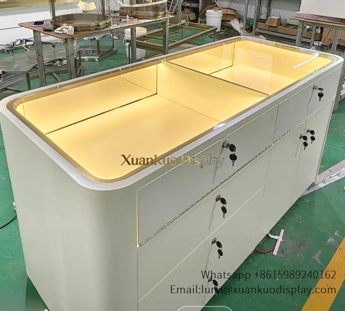 jewellery shop interior design Vietnam custom jewelry display cases, white curved jewelry showcase with warm LED lights, lockable storage drawers for jewellery boutique