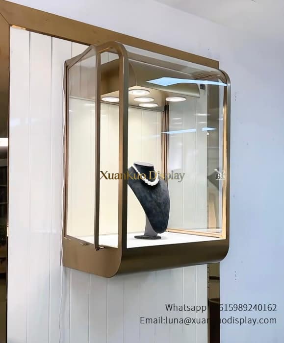 necklace display case, gold curved metal frame wall mounted glass display case with built-in LED spotlights for pearl necklace retail boutique
