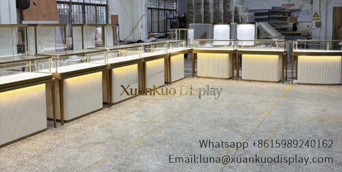 jewellery shop interior design Vietnam Modern jewelry showcase with fluted panel base, gold trim and LED light for jewelry retail shop