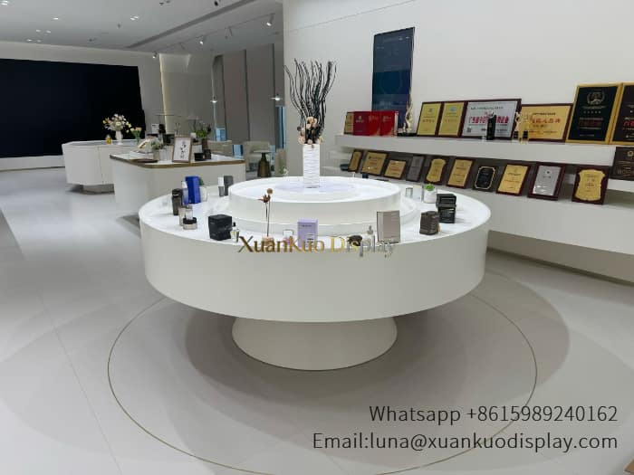 jewellery shop interior design Vietnam matte white two tier round perfume display island circular tiered central demo counter for fragrance beauty showroom