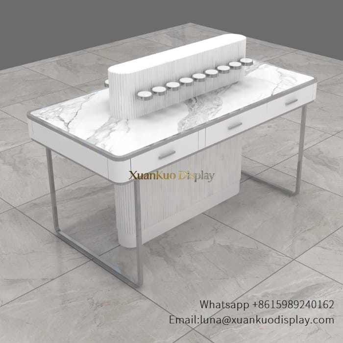 jewellery shop interior design Vietnam white marble silver metal perfume tester display table ribbed multi hole perfume bottle stand with storage drawers