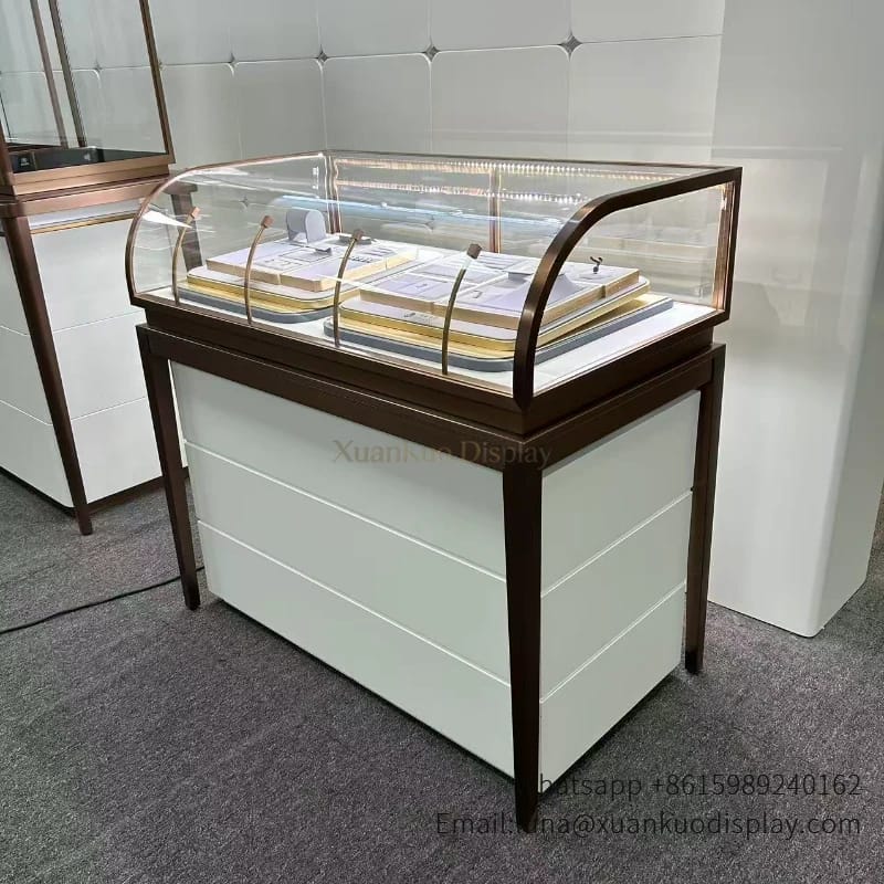 glass jewellery display cabinets curved top and bronze frame, LED lit showcase for luxury jewelry retail boutique, secure display counter for precious jewelry.